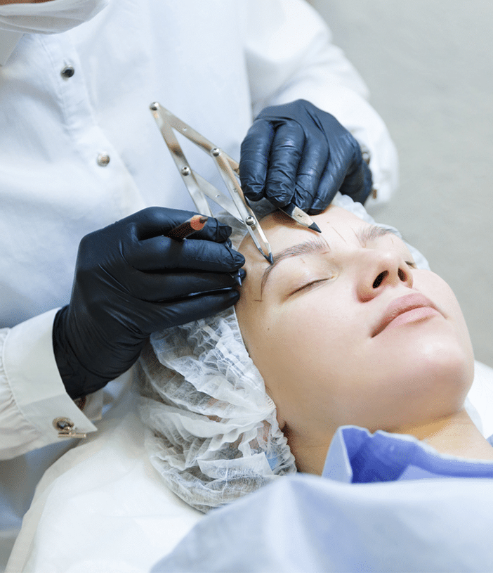 a woman's eyebrows being prepped for eyebrow transplant surgery